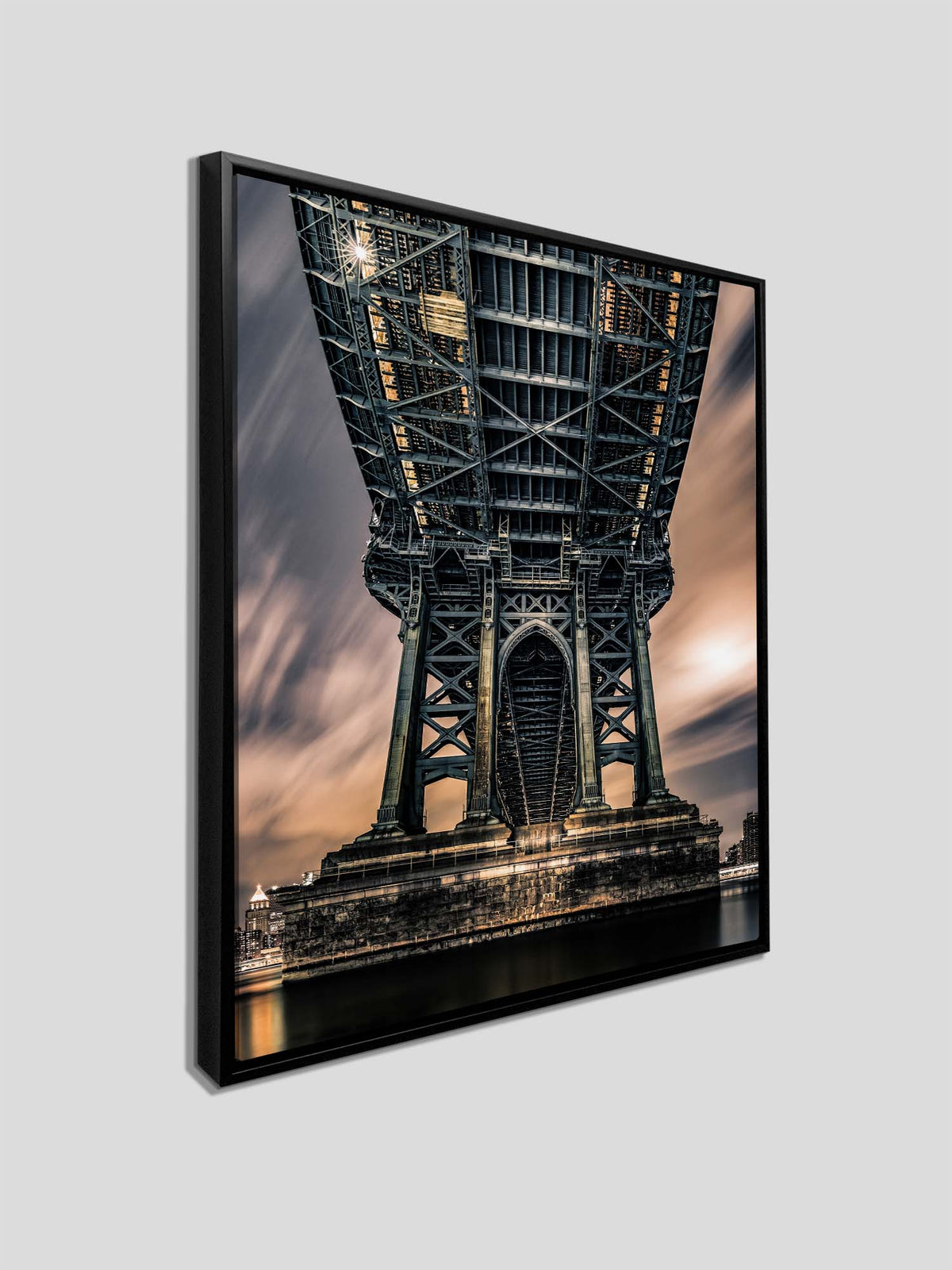 Symmetrical view beneath a steel bridge, with repeating crossbeams and a central arch against warm evening light — additional product view 4