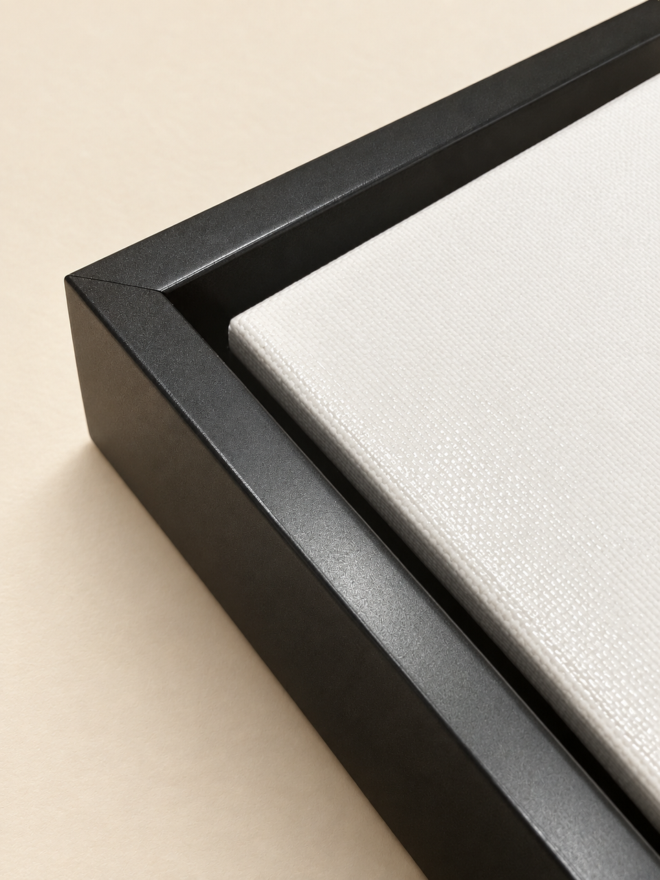 Close-up of a classic black floating frame with a recessed gap around the canvas.
